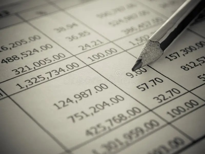 A page of accounts with a pencil pointing to the figures, representing a complete view of personal, property and business tax affairs